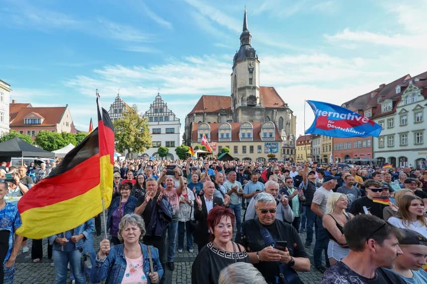 Crowds with German flags and an Alternative for Deutschland flag at a rally ahead of the Saxony-Anhalt election
