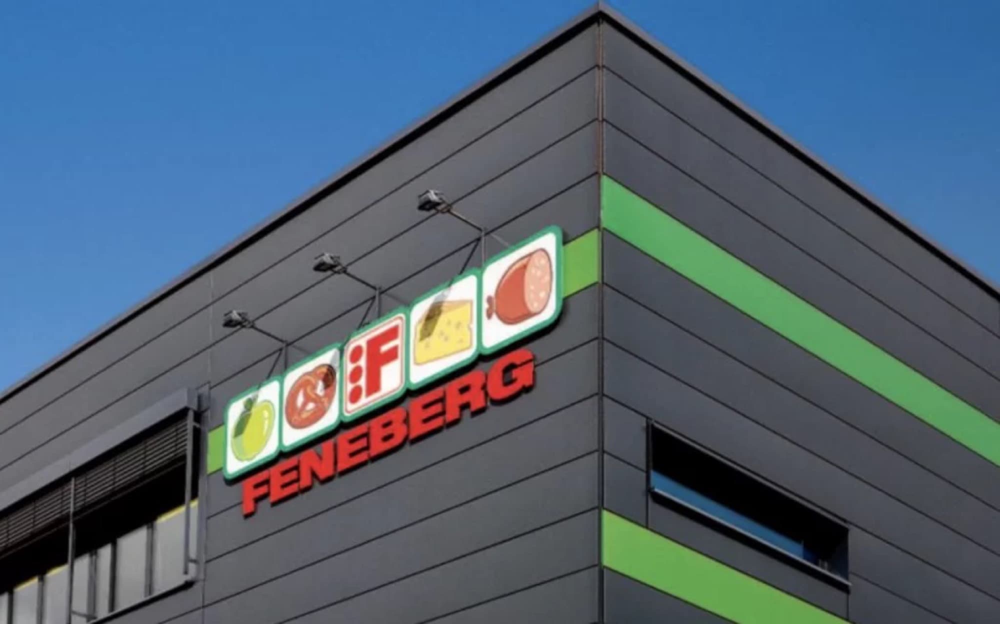 The Feneberg supermarket logo mounted on the corner of a dark modern store building