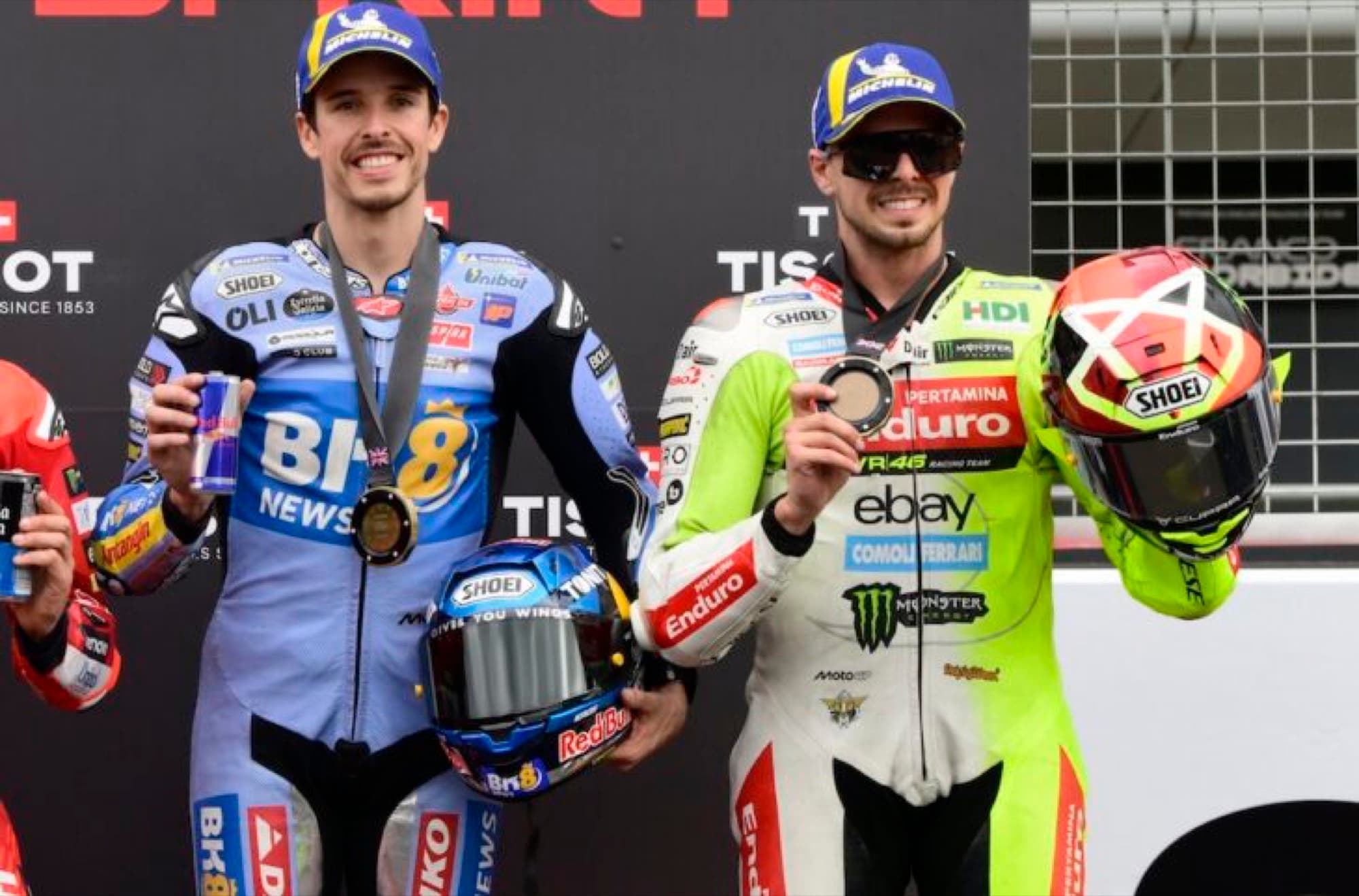 Two MotoGP riders celebrating with medals in parc ferme at the German Grand Prix