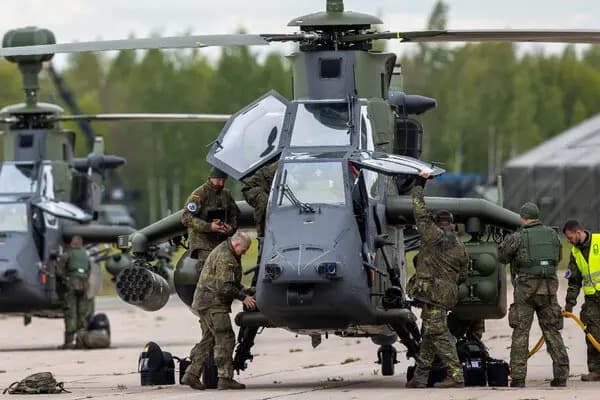 German soldiers prepare a Bundeswehr attack helicopter on an airfield