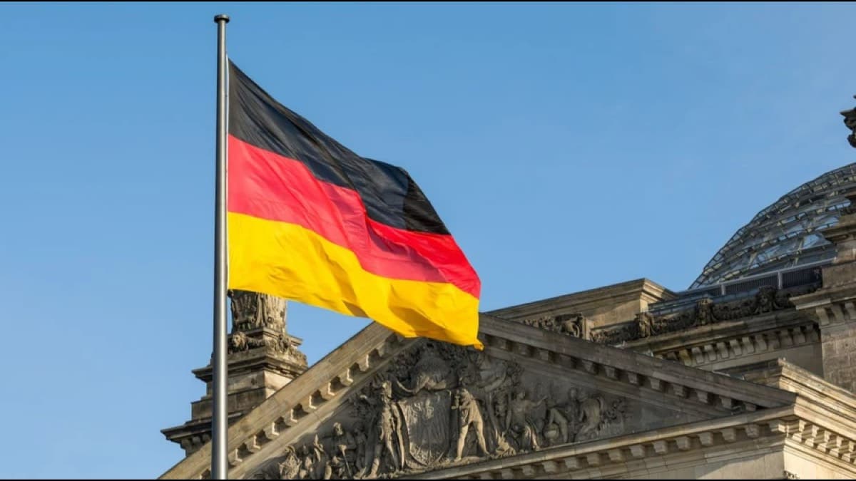 The German national flag flying in front of the Reichstag building in Berlin