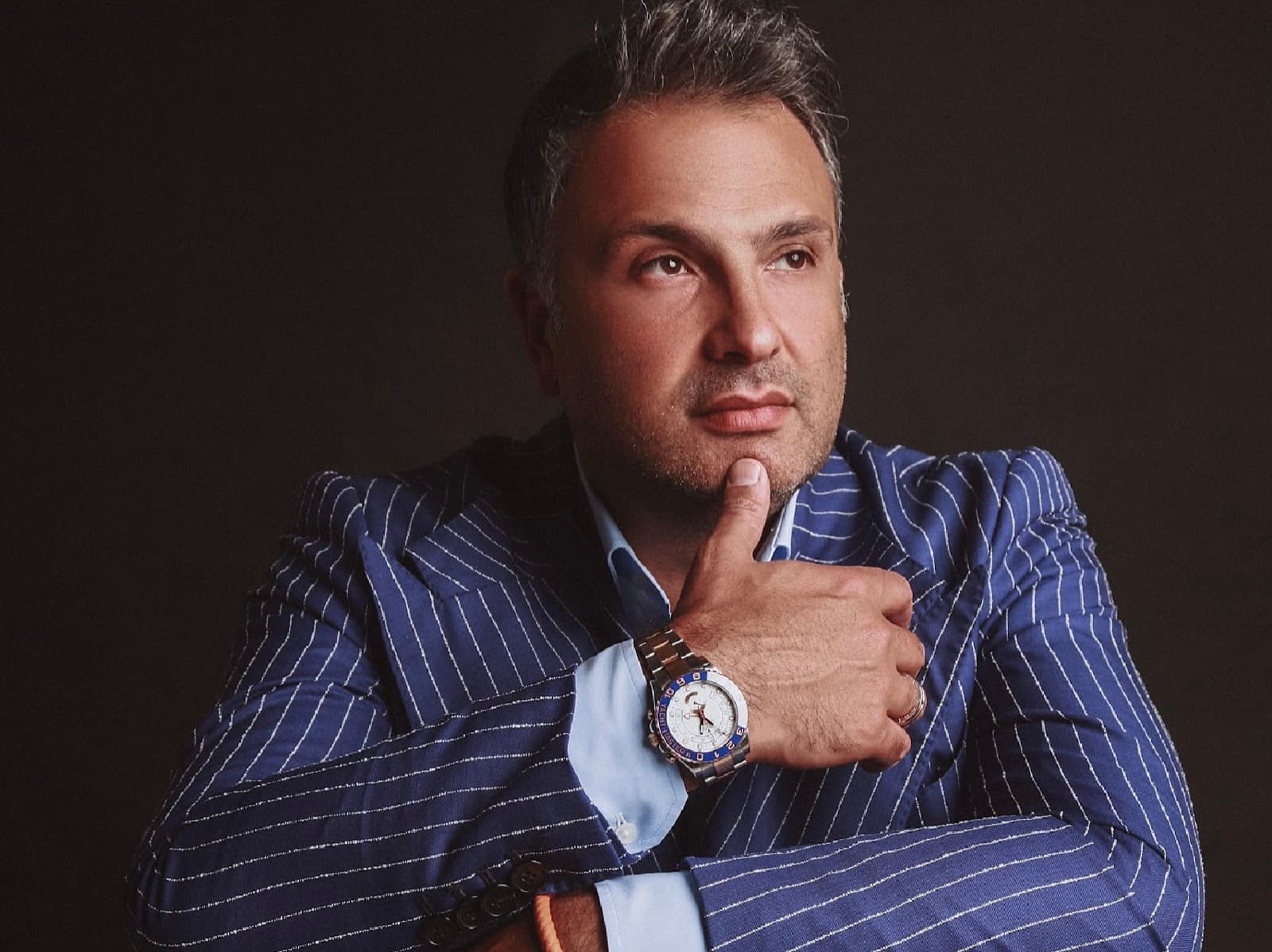 Maxim Berin, founder of Big Art Festival, in a blue pinstripe suit