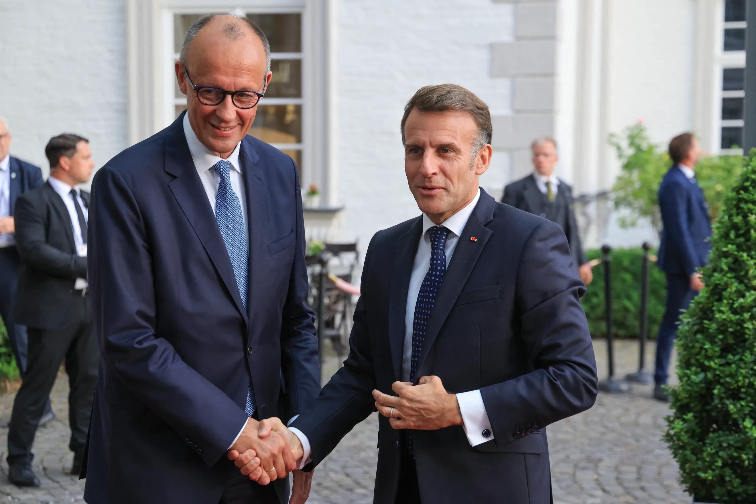 German Chancellor Friedrich Merz and French President Emmanuel Macron shaking hands