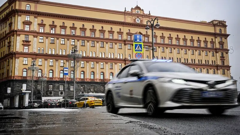 A police car driving past the FSB headquarters building in Moscow