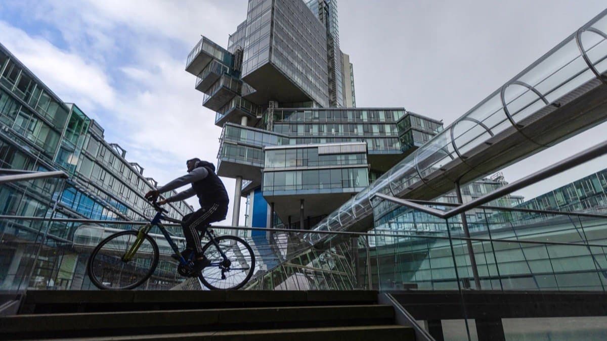 A cyclist passing the NordLB headquarters tower in Hannover, Germany