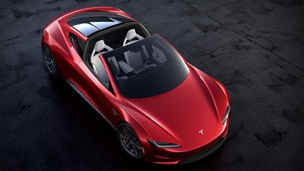 A red Tesla sports car photographed from above