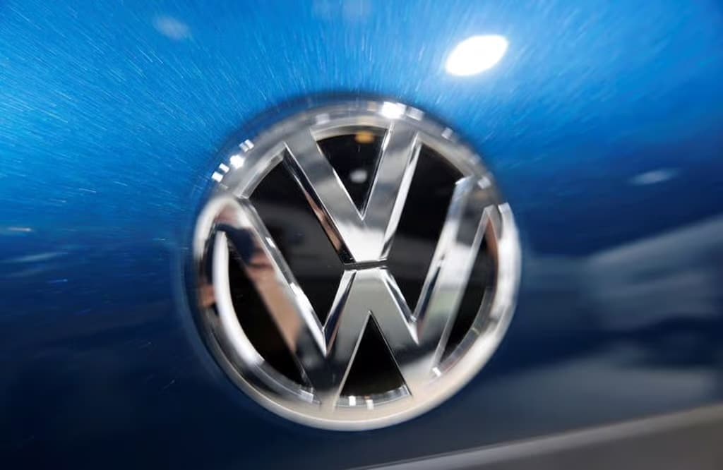 A close-up of the chrome Volkswagen logo on a blue car