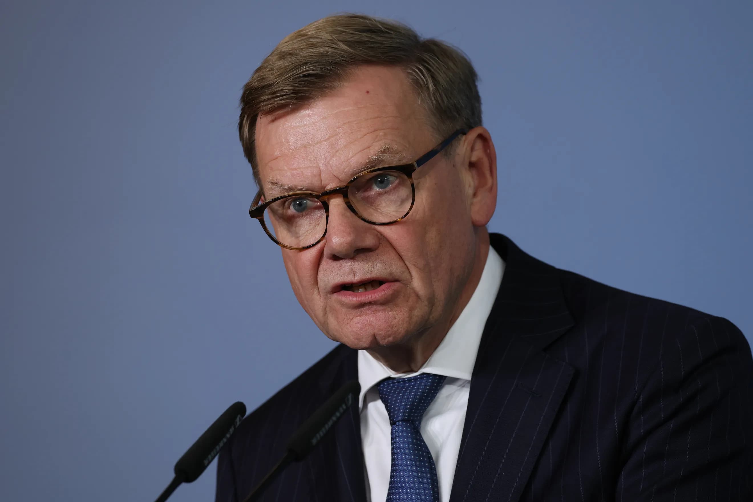 German Foreign Minister Johann Wadephul speaking at a podium