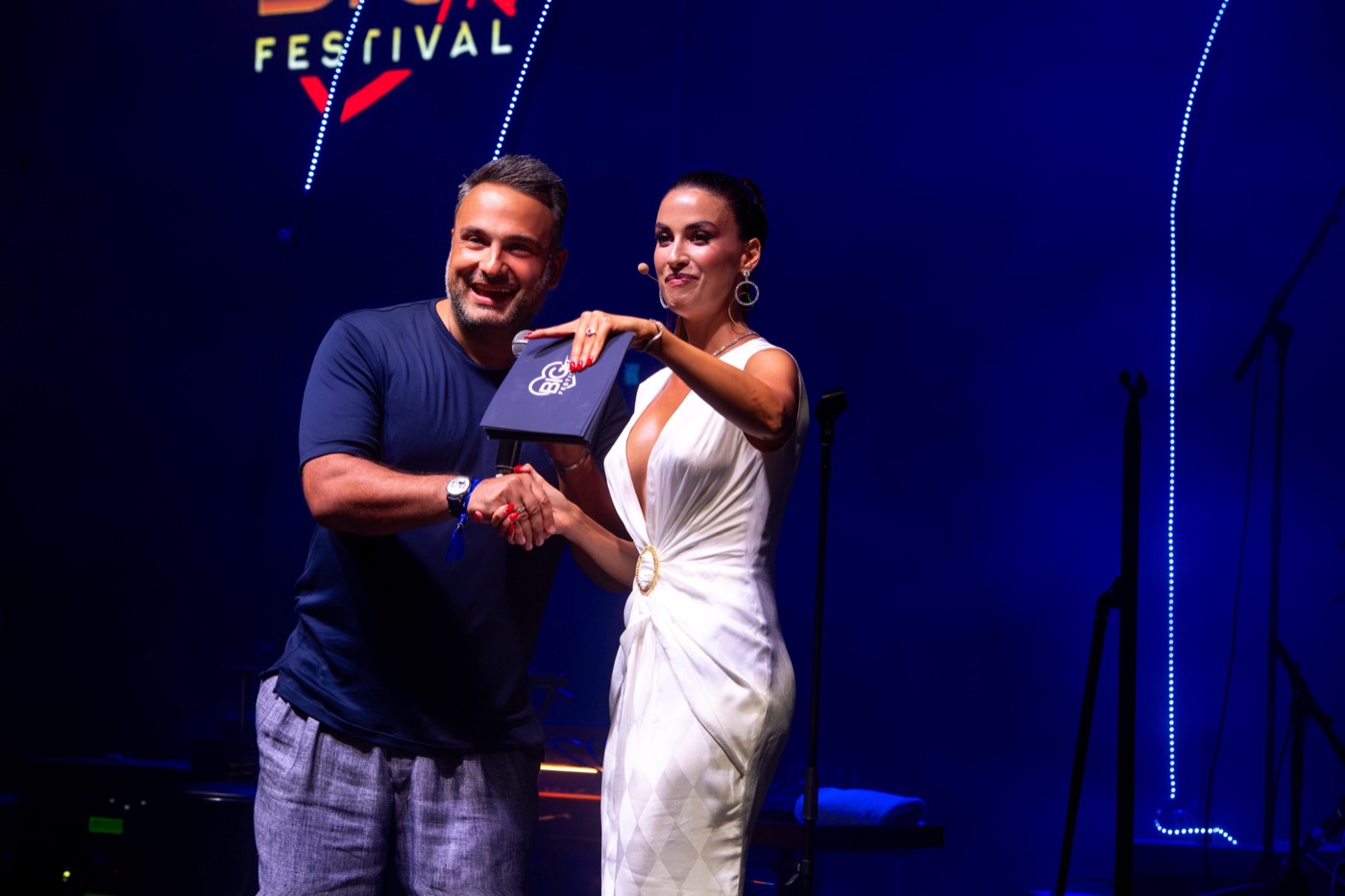 Host Eleonora Incardona in a white gown on the BIG ART Festival stage