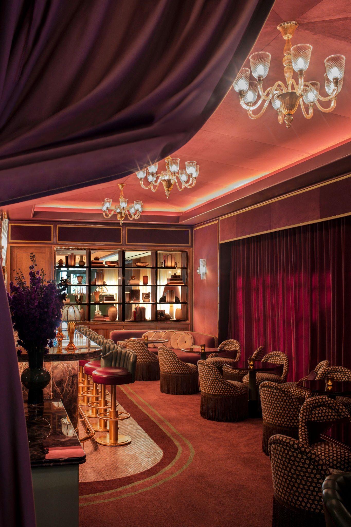 The velvet and chandelier interior of the Two E Lounge at The Pierre in the evening