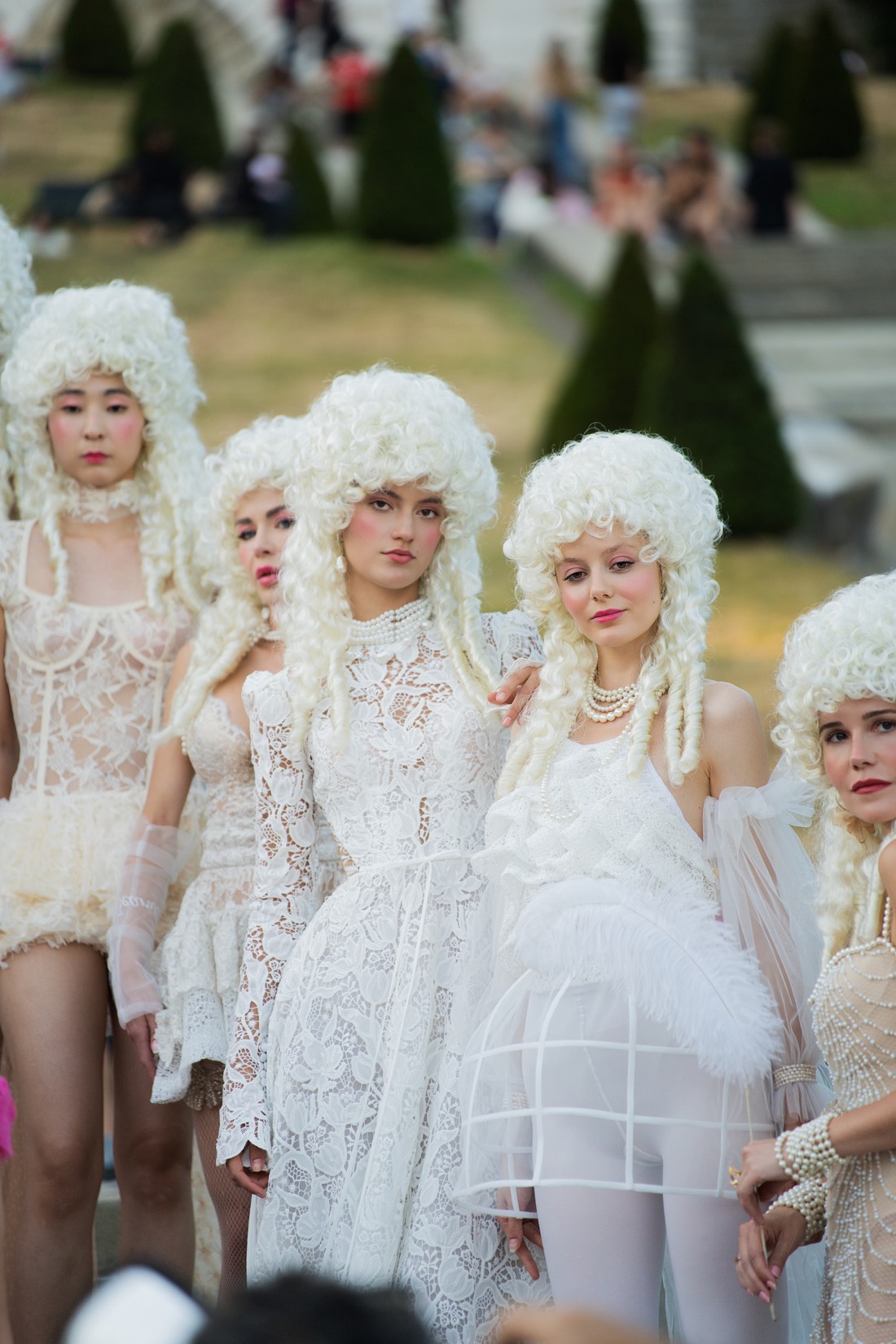 Models in powdered wigs and pale couture at the Carrousel de Saint-Pierre in Montmartre